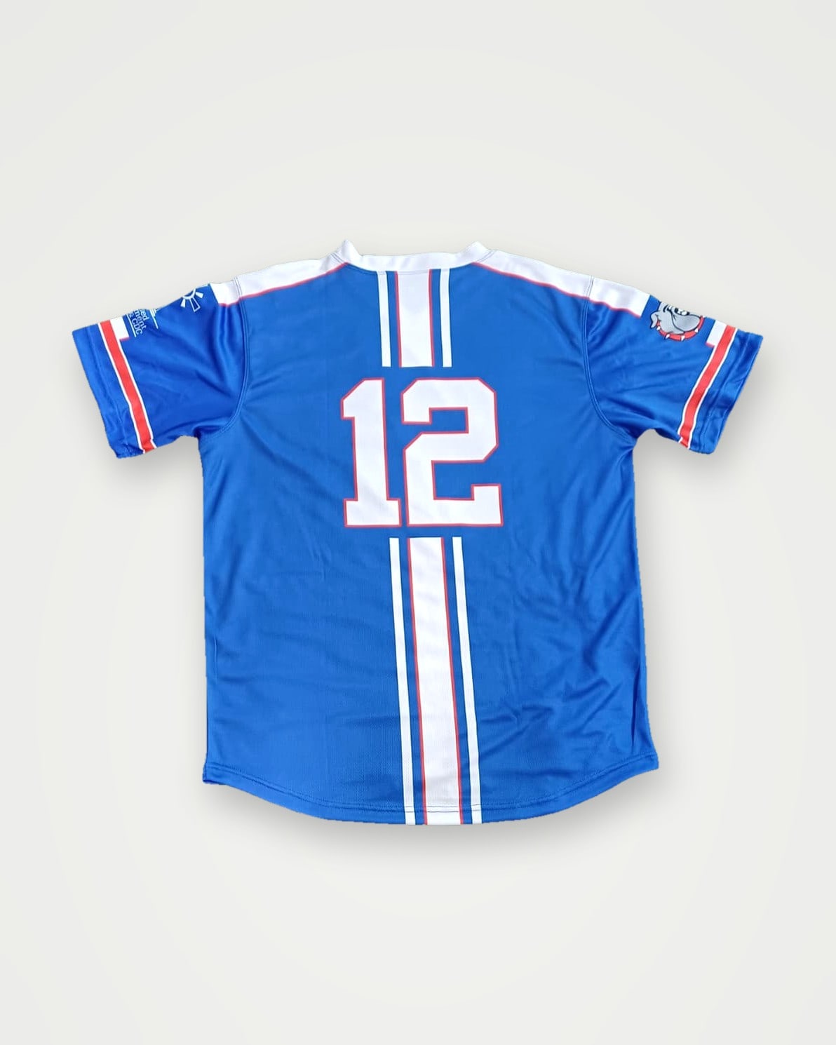 Back of a blue baseball jersey with white stripes and number 12