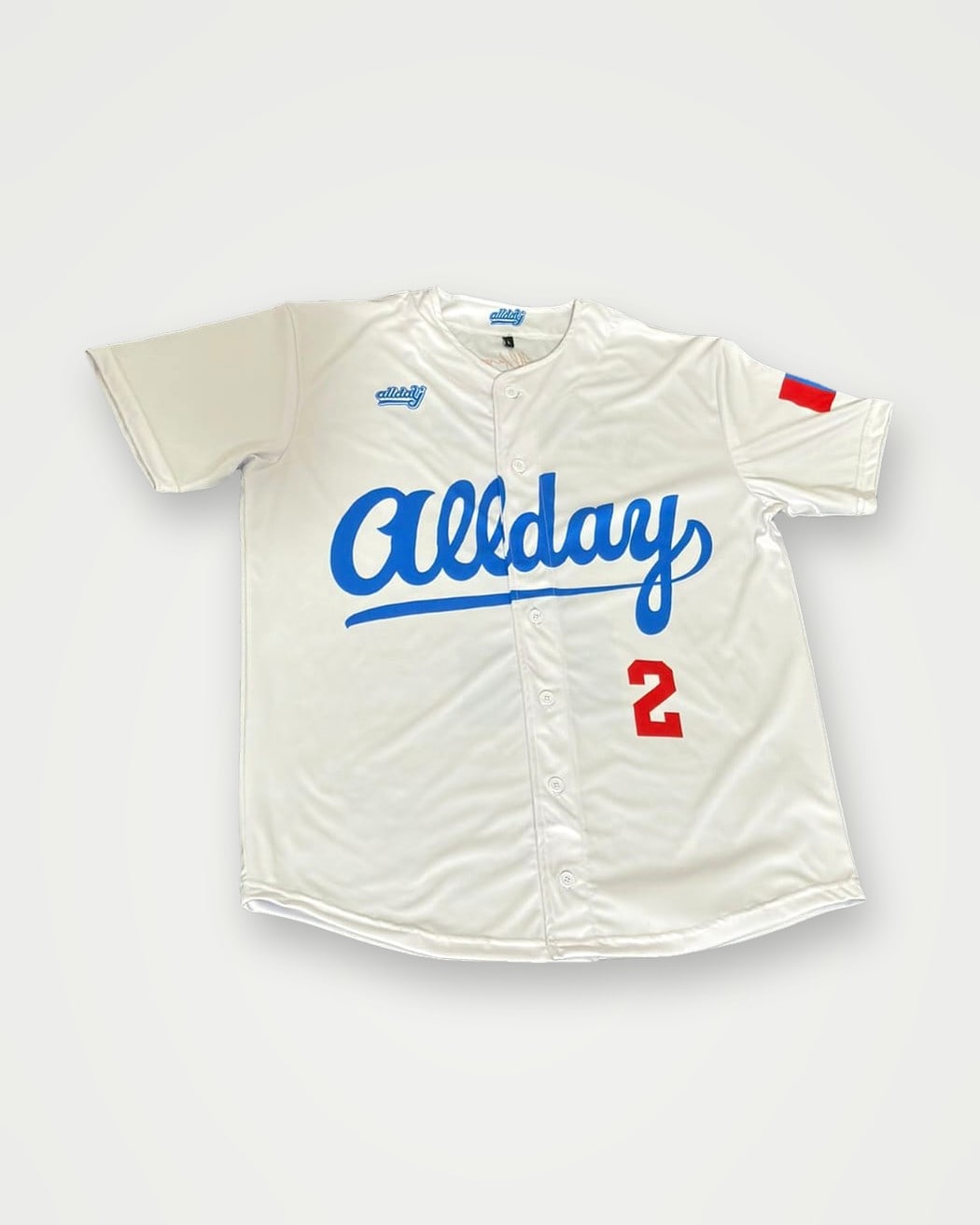 White button-front baseball jersey with blue script lettering and number 2