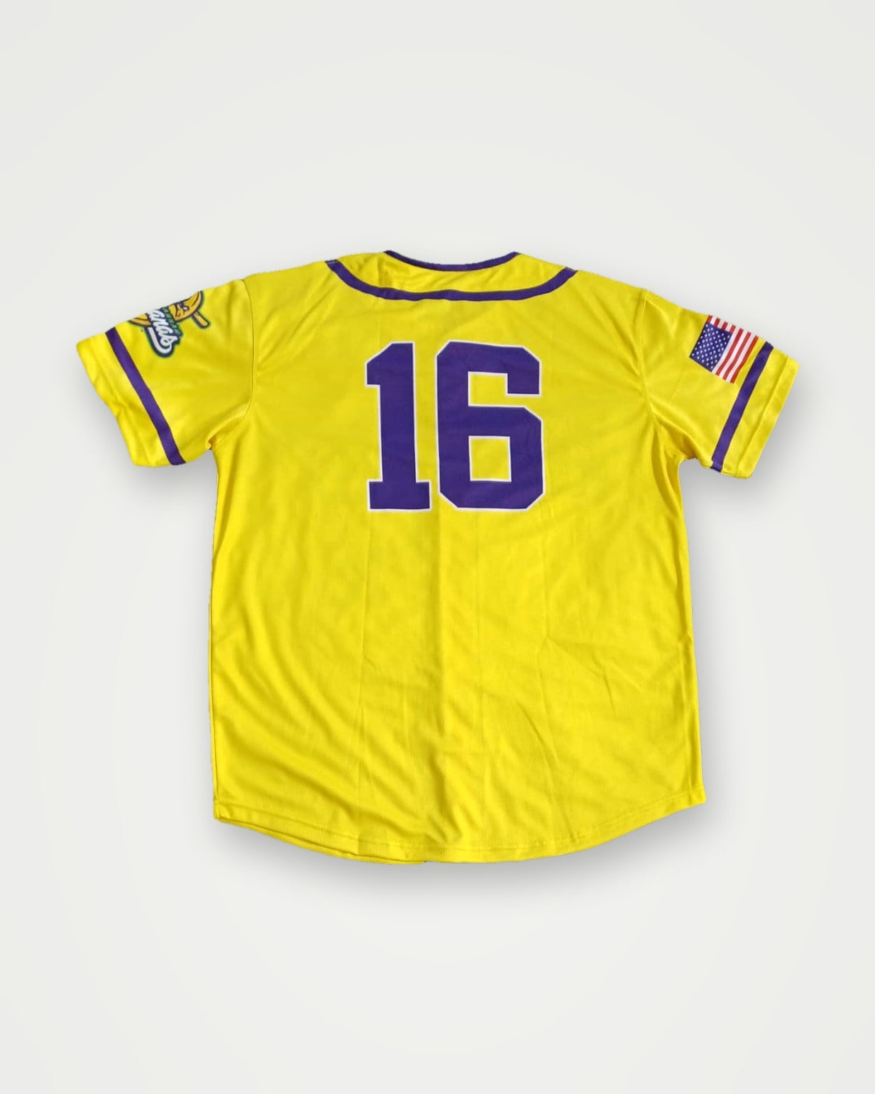 Back of a yellow baseball jersey with purple number 16