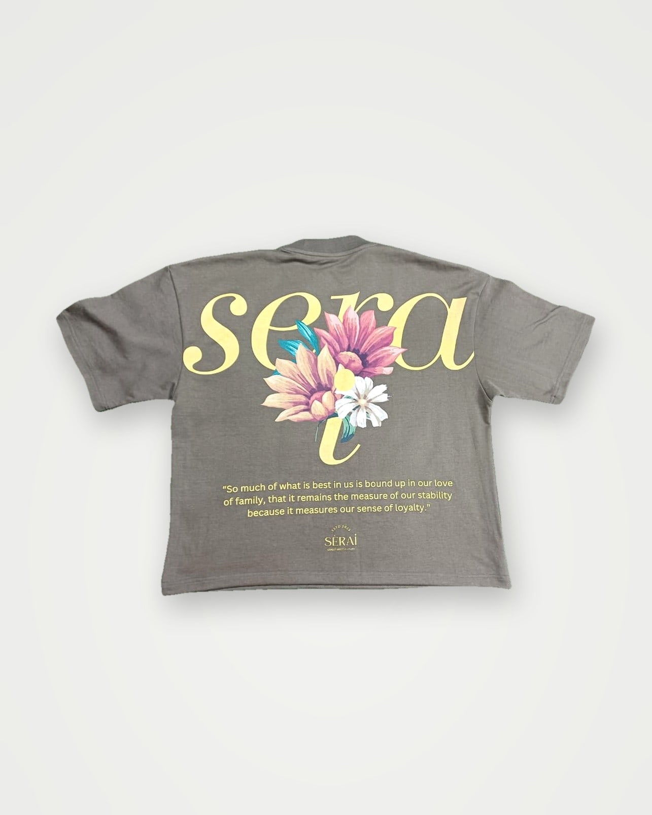 Grey boxy t-shirt with a yellow script and floral back print