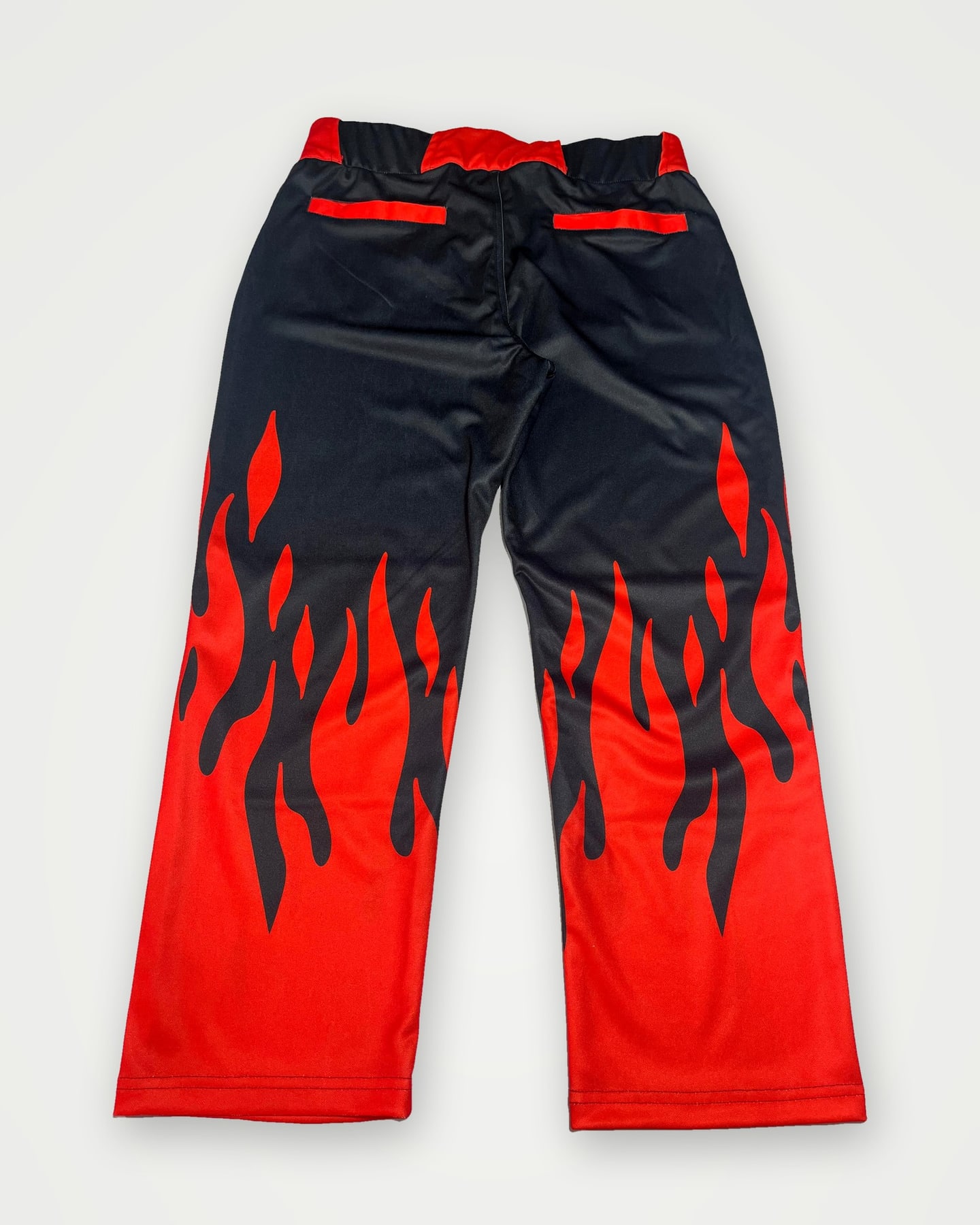 Black track pants with red flame print
