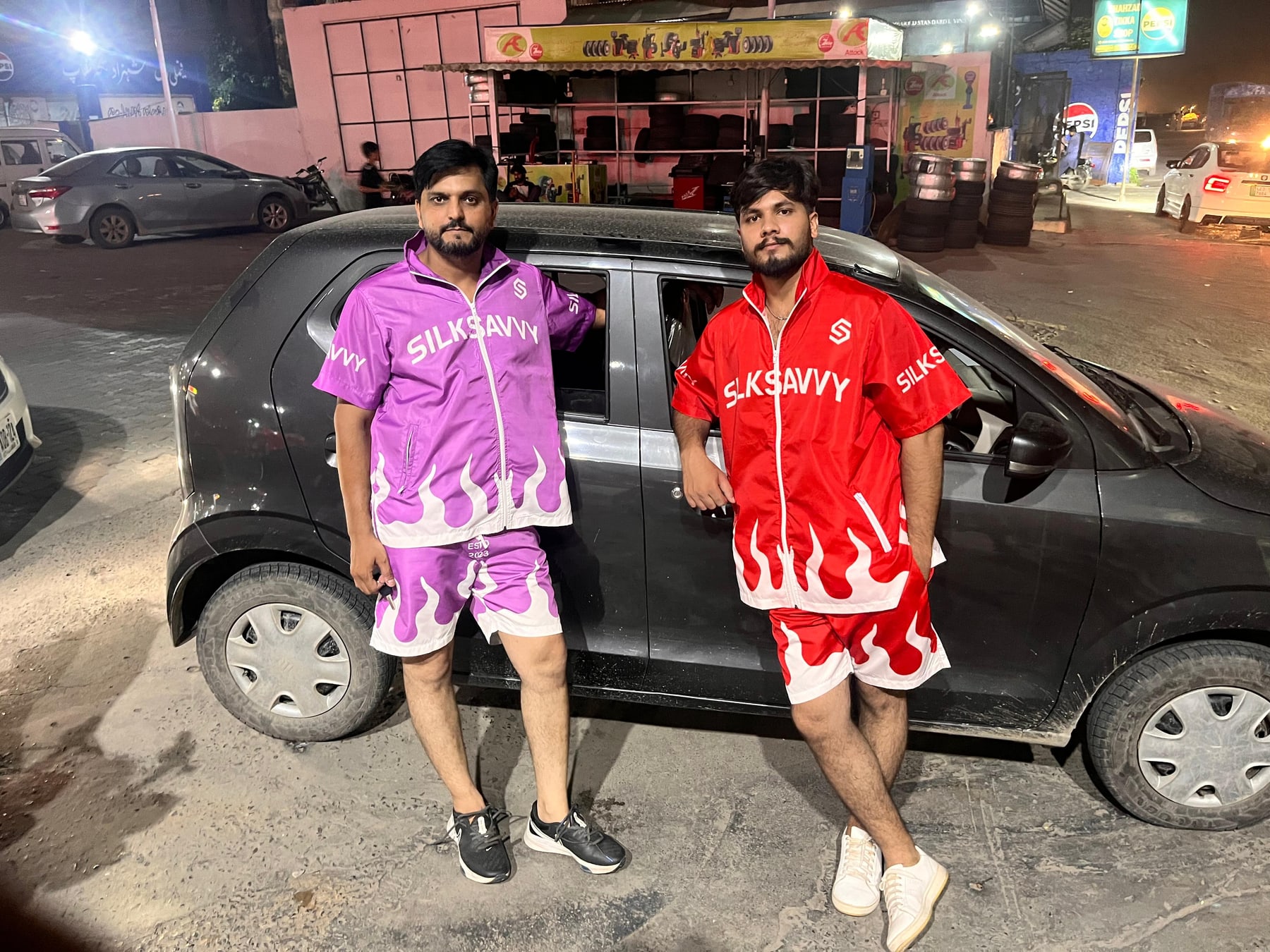 Purple and red flame-print shirt and shorts sets, worn