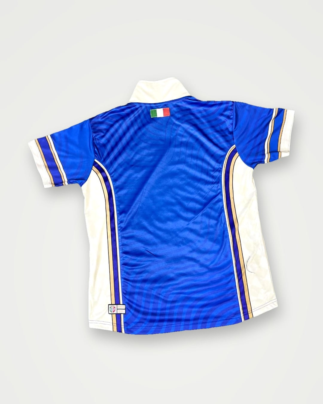 Back of a blue retro football shirt with white side panels