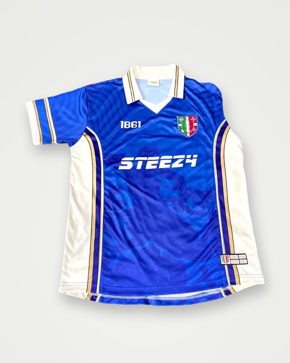 Blue football shirt with a white retro collar and chest print