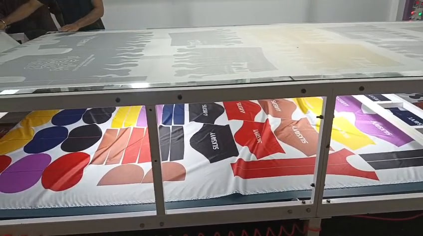 Printed panels passing through a heat transfer press