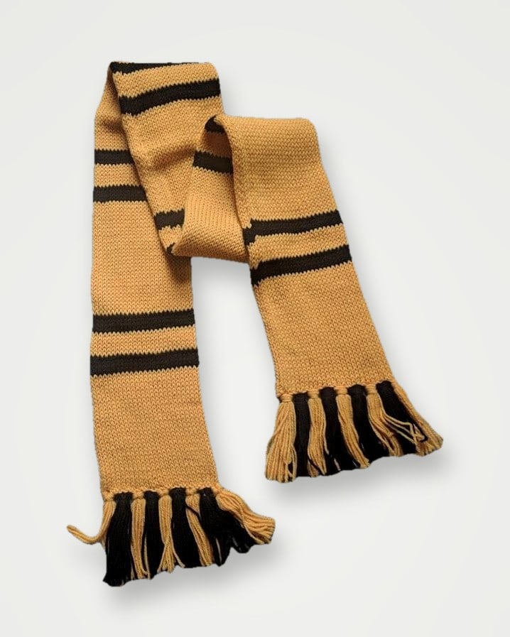 Tan knitted scarf with black stripes and tassels