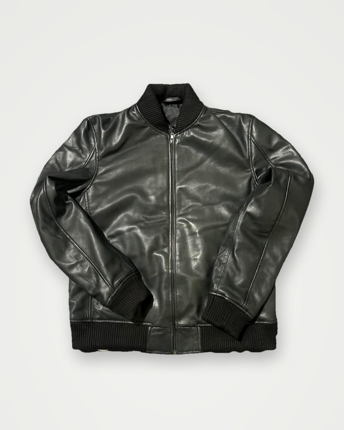 Black leather bomber jacket with ribbed collar, cuffs and hem