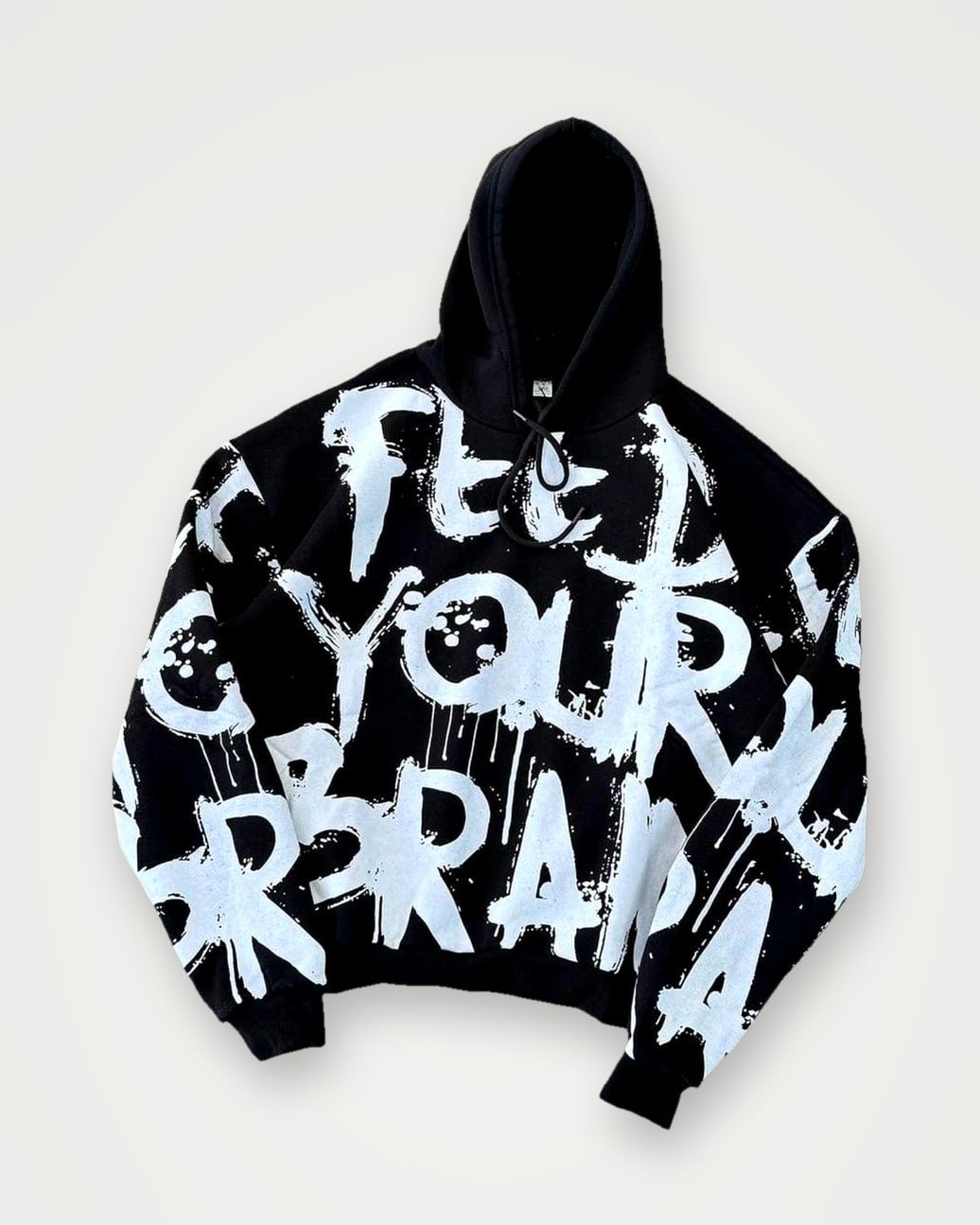 Black oversized hoodie with an all-over white brush-lettering print