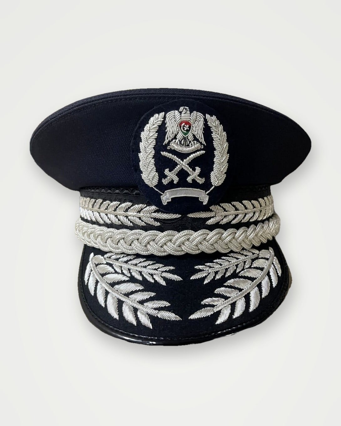 Navy peak cap with silver bullion embroidery and badge
