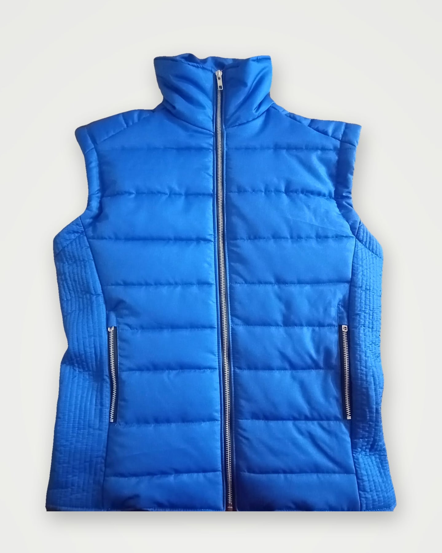 Royal blue quilted gilet with ribbed side panels