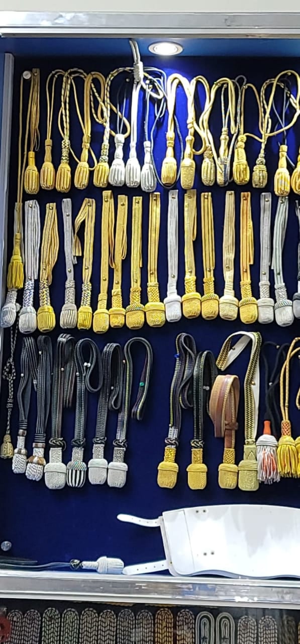 Wall of braided cords and aiguillettes in gold, silver and colours