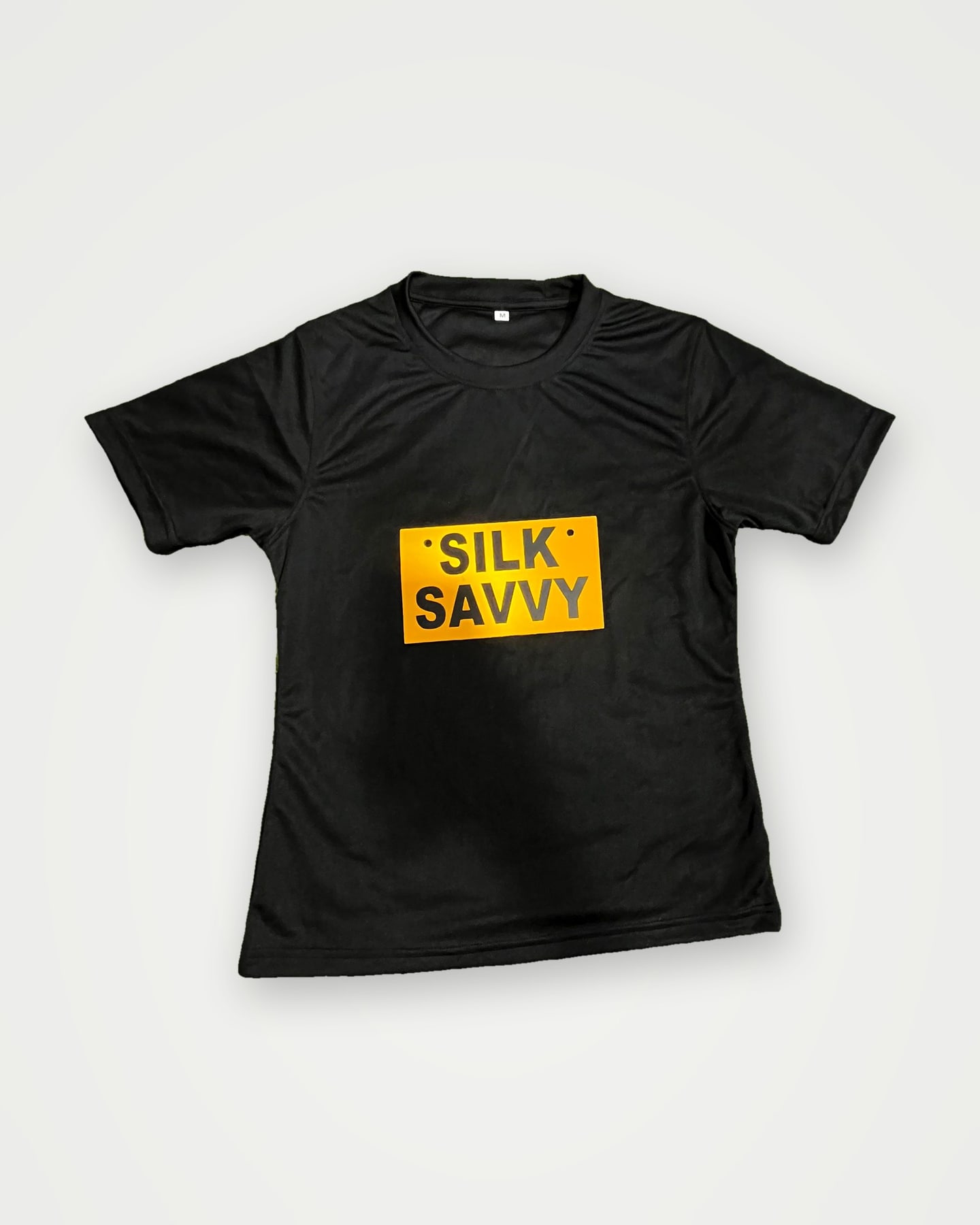 Black performance t-shirt with an orange Silksavvy chest label