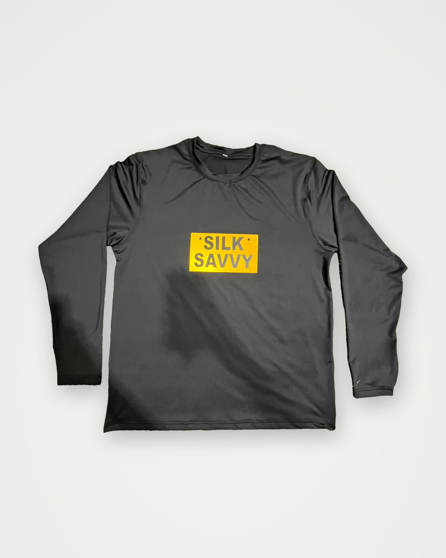 Black long-sleeve t-shirt with an orange Silksavvy chest label