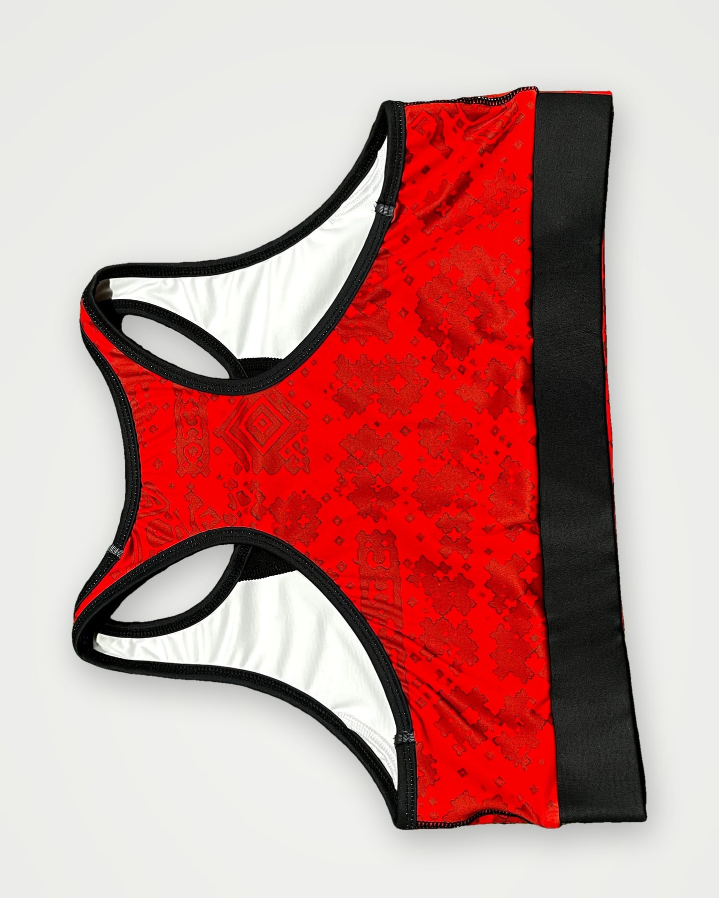 Red patterned sports bra with black under-band