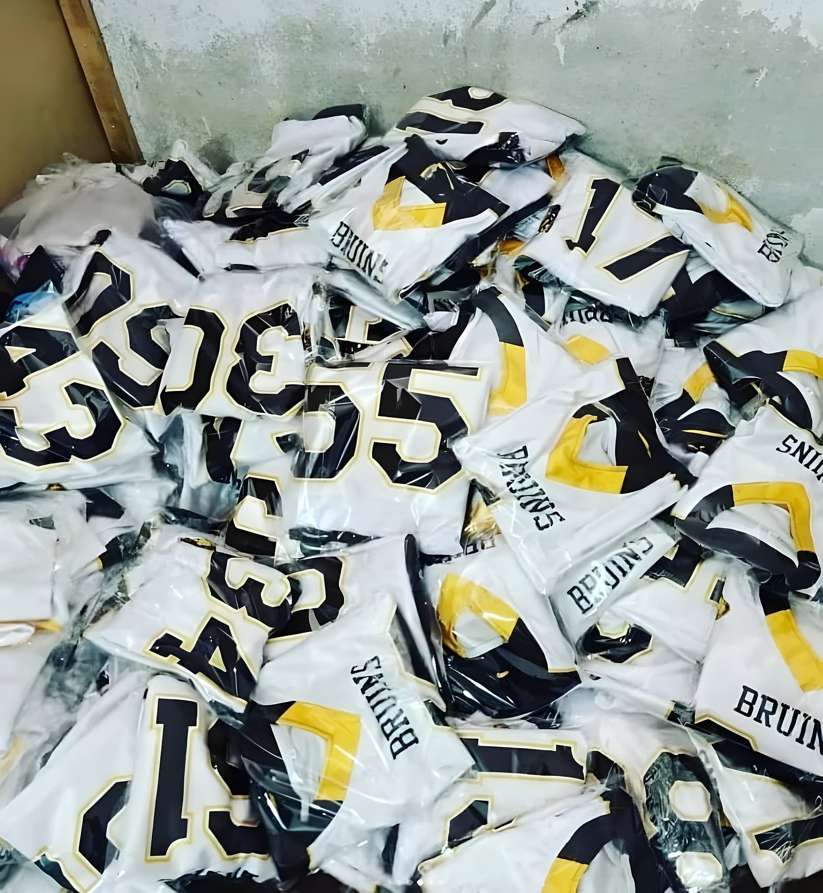 Finished white, black and gold team jerseys bagged individually ahead of dispatch