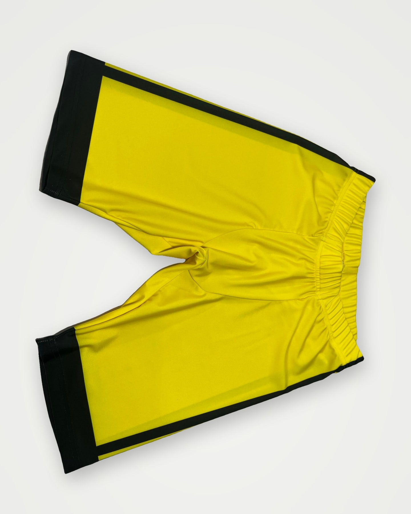 Yellow training shorts with black side panels
