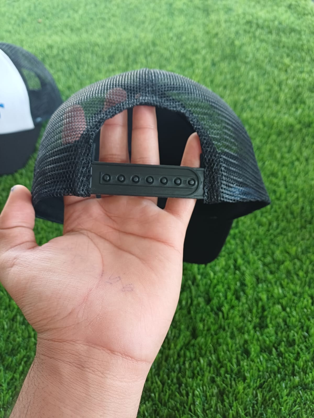 Snapback closure and mesh back of a trucker cap