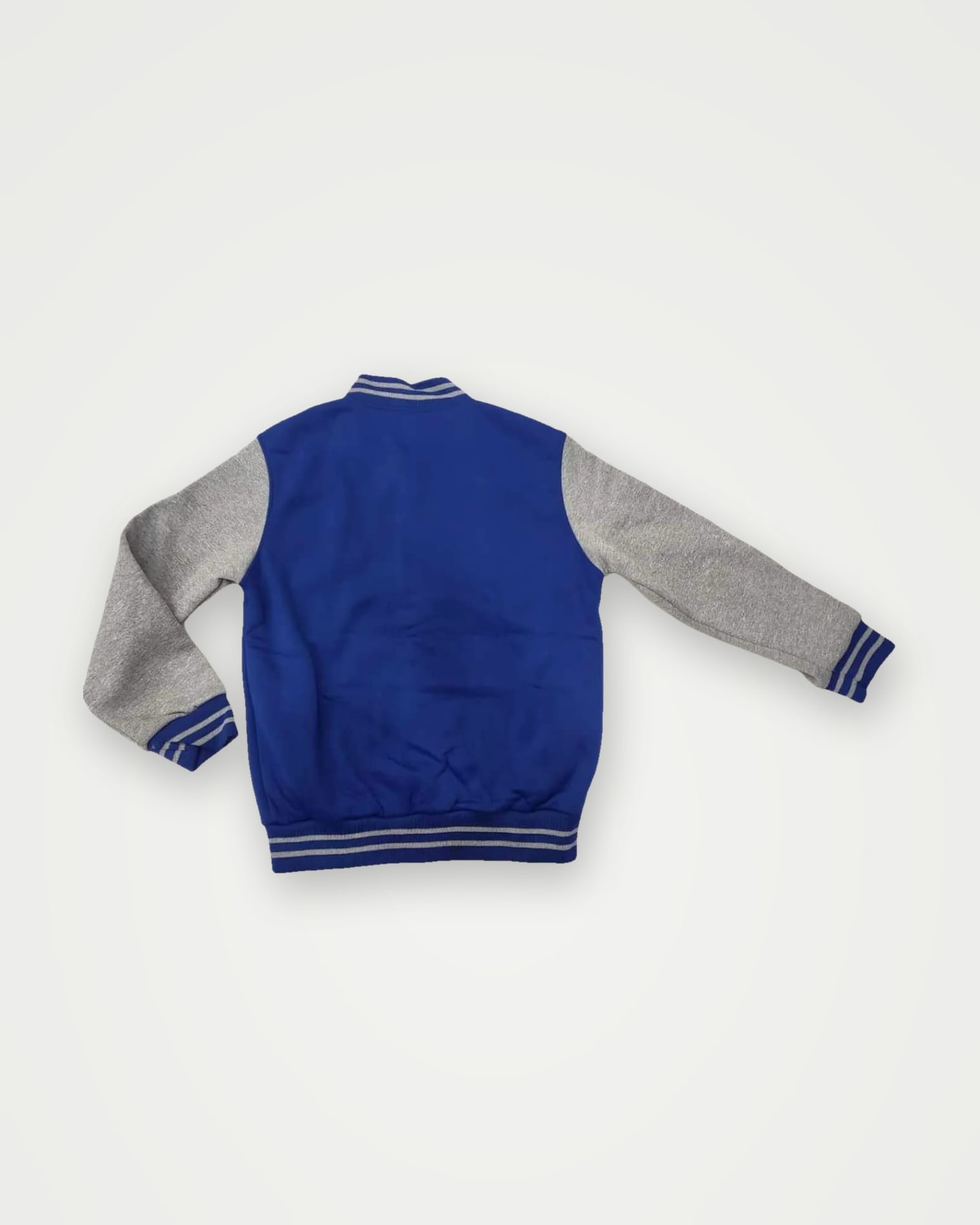 Back of a royal blue varsity jacket with grey sleeves