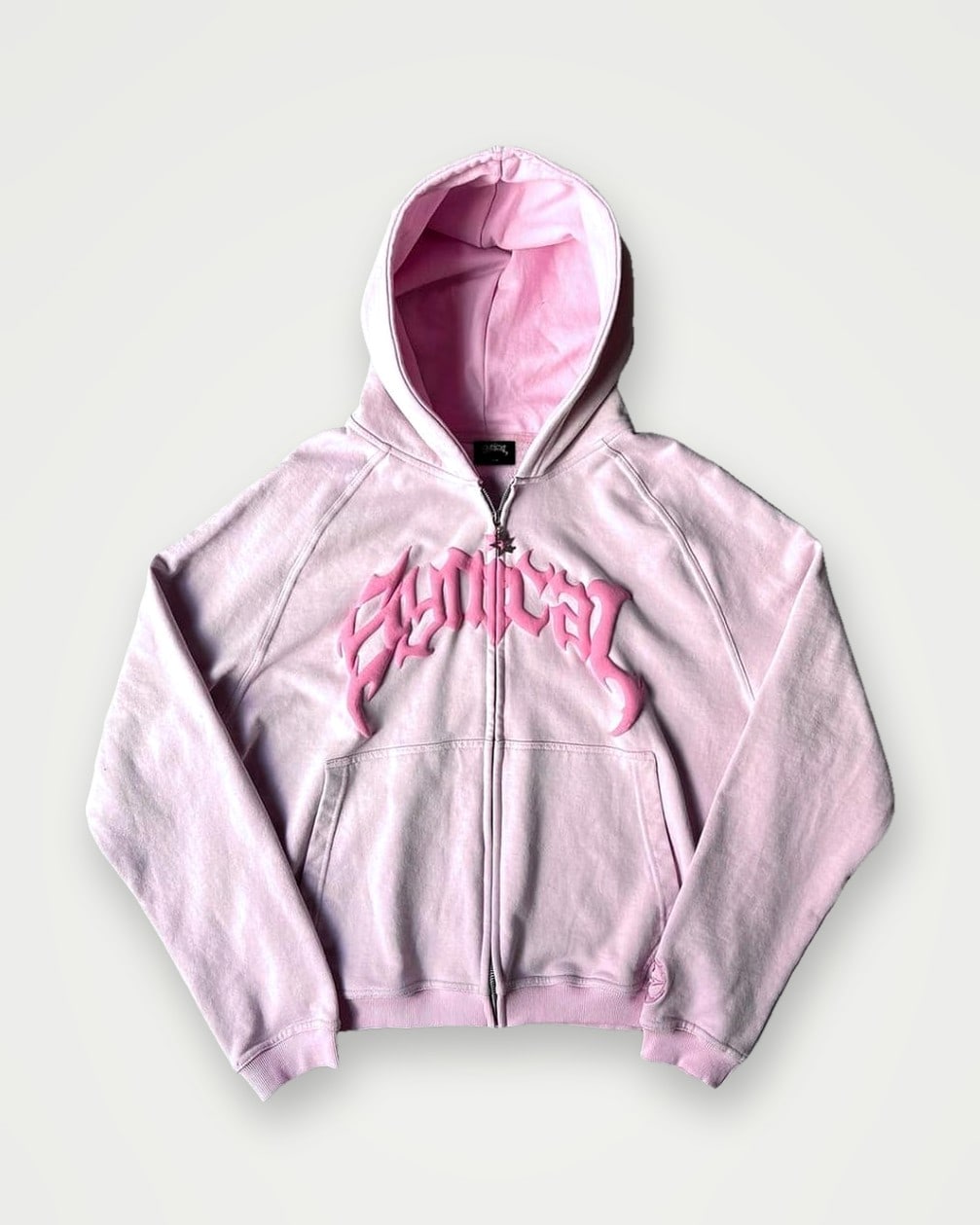 Pale pink zip hoodie with tonal appliqué lettering